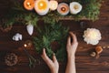 Florist hands making rustic christmas wreath with fir branches, flat lay Royalty Free Stock Photo