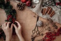 Rustic Christmas wreath flat lay. Hands holding fir branches, re Royalty Free Stock Photo