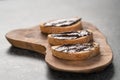 Rustic ciabatta with organic chocolate cream on olive wood board