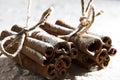 RUSTIC CINNAMON AND ANISE STILL LIFE ON SNOW COVERED BACKGROUND