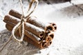 RUSTIC CINNAMON STILL LIFE ON SNOW COVERED BACKGROUND