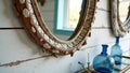 Rustic coastal mirror with shells in bright nautical bathroom setting Royalty Free Stock Photo