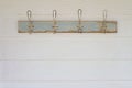 Rustic coat hooks background on white weatherboard house Royalty Free Stock Photo