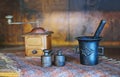 Rustic coffee grinder, weights and casted mortar still nature Royalty Free Stock Photo