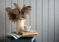 Rustic coffee still life with pampas grass and book Royalty Free Stock Photo
