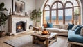 Rustic coffee table between sofa and chairs against fireplace and arched windows. Mediterranean modern cottage style home interior Royalty Free Stock Photo