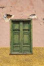 Rustic colorful window shutters on a cracked wall Royalty Free Stock Photo