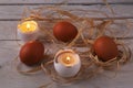 Rustic composition with candles and eggs. Happy easter. Selective focus. Royalty Free Stock Photo