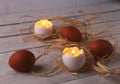 Rustic composition with candles and eggs. Happy easter. Selective focus. Royalty Free Stock Photo