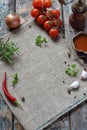 Rustic composition with pepper mill, tomato souce, fresh herbs, vegetables and spices. Country style. Baking or cooking background Royalty Free Stock Photo