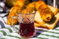 Rustic composition with traditional alcoholic drink cherry brandy in a glass cup