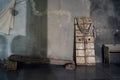 Rustic concrete designer interior with old wooden door, bench and column. Natural light with shadows on the wall. Inspiration