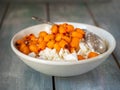 Rustic cottage cheese m frozen sea buckthorn berries in a deep white plate for a light snack Royalty Free Stock Photo