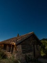 Rustic country house at night under the stars Royalty Free Stock Photo