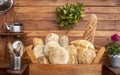 Rustic country kitchen in recycled wood. Large selection of fresh bread of various types in a wooden basket Royalty Free Stock Photo