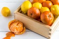 Rustic crate with whole fruit lemons and clementines