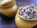 Traditional rustic cuisine of Belarus, Ukrain and Russia : Boiled buckwheat in a ceramic bowl close up view