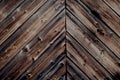 Rustic dark antique stained wood wall with aged, cracked wooden planks and nails in the countryside
