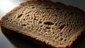 Rustic Dark Bread Slice Close-up with Dramatic Lighting Royalty Free Stock Photo