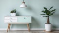 Rustic decor with a modern twist: white wooden cupboard with minimalistic mint lampshade and fresh plant, perfect for cozy home