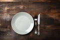 Rustic dining style Empty plate, fork, knife on gray wood Royalty Free Stock Photo