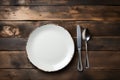 Rustic dining style Empty plate, fork, knife on gray wood Royalty Free Stock Photo