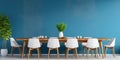 Rustic dining table and white chairs against of blue stucco wall with wooden slab as wall decor. Interior design of modern room Royalty Free Stock Photo