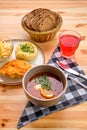 Chicken fillet in breading, mashed potato and pickle cabbage with saltwort soup, brown bread and a glass of Royalty Free Stock Photo