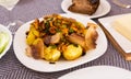 Traditional rustic dish. fried potatoes with chanterelle mushrooms and pork brisket with herbs Royalty Free Stock Photo