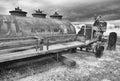 Rustic early farm tractor and gas container, infrared