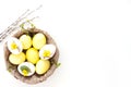 Rustic Easter background with yellow and white eggs Royalty Free Stock Photo
