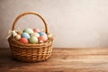Rustic Easter Basket with Colorful Eggs on Wooden Table Royalty Free Stock Photo