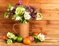 Rustic Easter still life. Easter eggs, blossoms Hellebore flowers in rustic jug Royalty Free Stock Photo