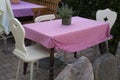 Rustic empty outdoor tables and chairs with tableclothes Royalty Free Stock Photo