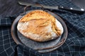 Rustic european spelt flour loaf of bread on iron tray