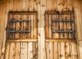 Rustic facade of a wooden house with wooden shutters Royalty Free Stock Photo