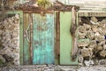 Rustic faded aqua garden doorway surrounded by a rock wall in Key West, Florida