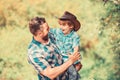 Rustic family. Growing cute cowboy. Small helper in garden. Little boy and father in nature background. Spirit of Royalty Free Stock Photo