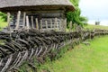 Rustic fence in village near the house near the forest. Authentic traditional culture in architecture and life. Old wooden