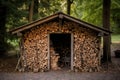 rustic firewood shed filled with split logs Royalty Free Stock Photo