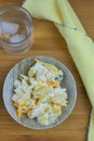 Rustic flat lay with bowl of cheese pasta salad on a wood table or desk