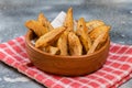 Rustic fried potatoes with herbs in a ceramic bowl on a concrete surface Royalty Free Stock Photo