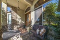 Rustic front entrance of a house with stone veneer siding and reflective arched glass window Royalty Free Stock Photo