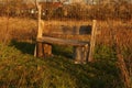 Rustic garden bench made of recycled wood. Easy DYI bench made of tree trunks, recycled wooden fence boards, and Royalty Free Stock Photo