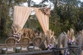 A rustic garden wedding setup, with wooden chairs and benches, and a simple altar arch and aisle. Royalty Free Stock Photo