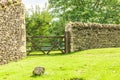 Rustic gate in drystone wall in Bibury England UK.