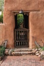 Rustic gate at entrance through adobe wall in Santa Fe, New Mexico Royalty Free Stock Photo