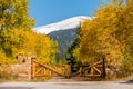 Rustic gate made of logs on unpaved road
