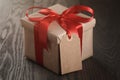 Rustic gift box with red ribbon bow and emmpty tag