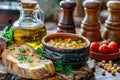Rustic Gourmet Breakfast with Chickpea Soup, Olive Oil, Fresh Tomatoes, and Garlic Bread on Wooden Table Royalty Free Stock Photo
